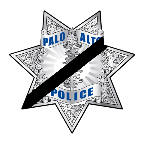 Police badge with black mourning band draped over it