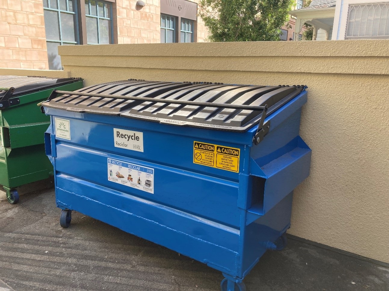 a clean blue dumpster with a closed lid